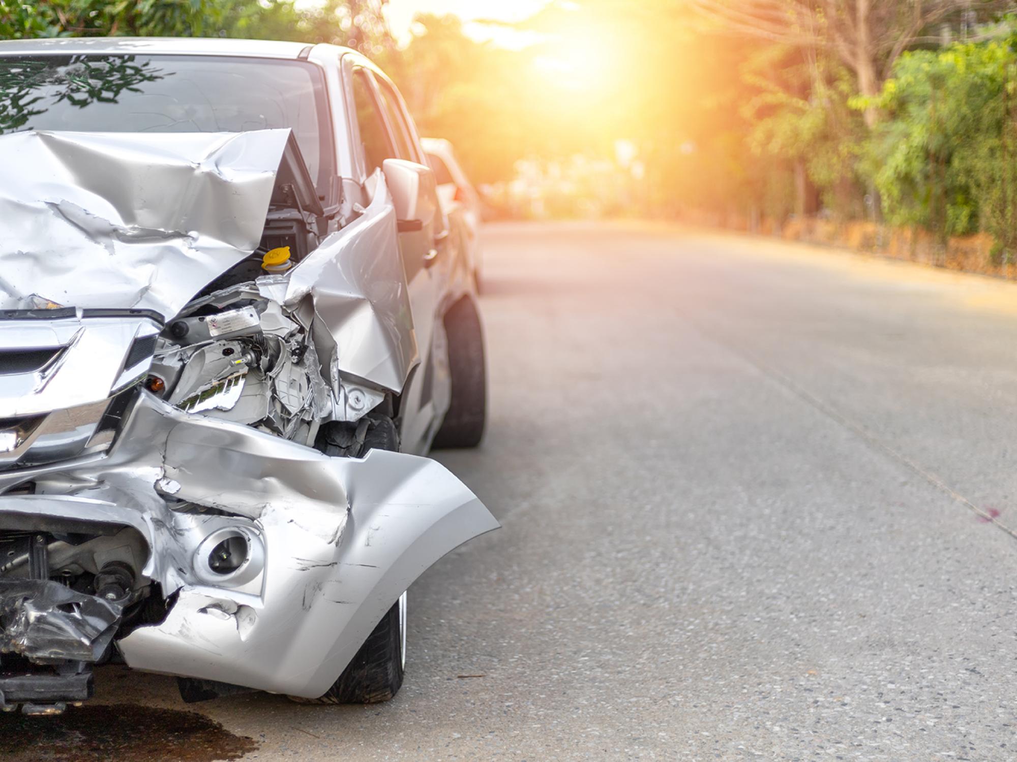 A destroyed car at dusk